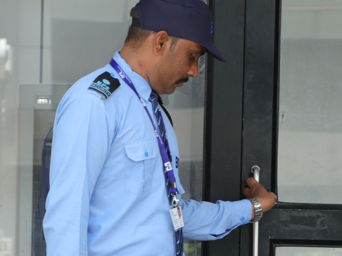 security guard standing out atm door