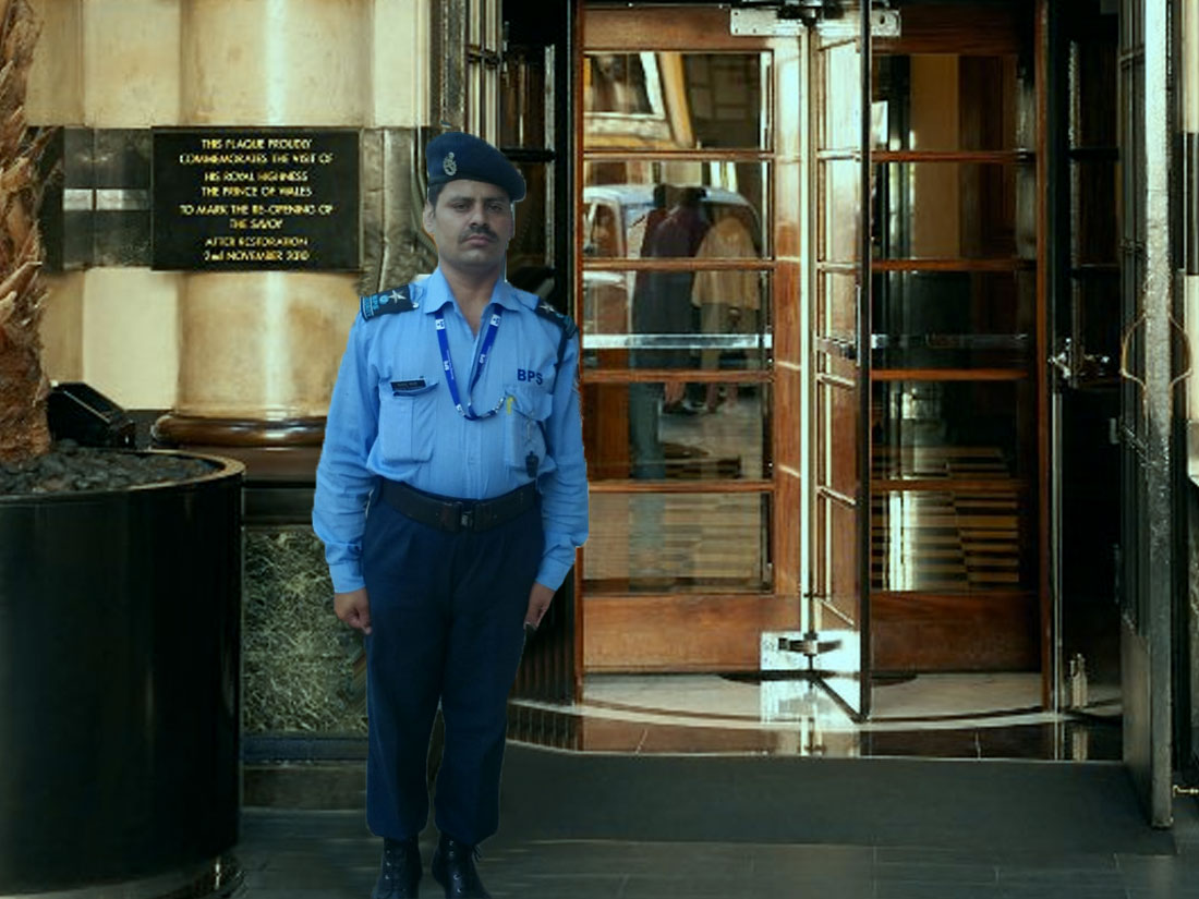 doorman standing outside hotel